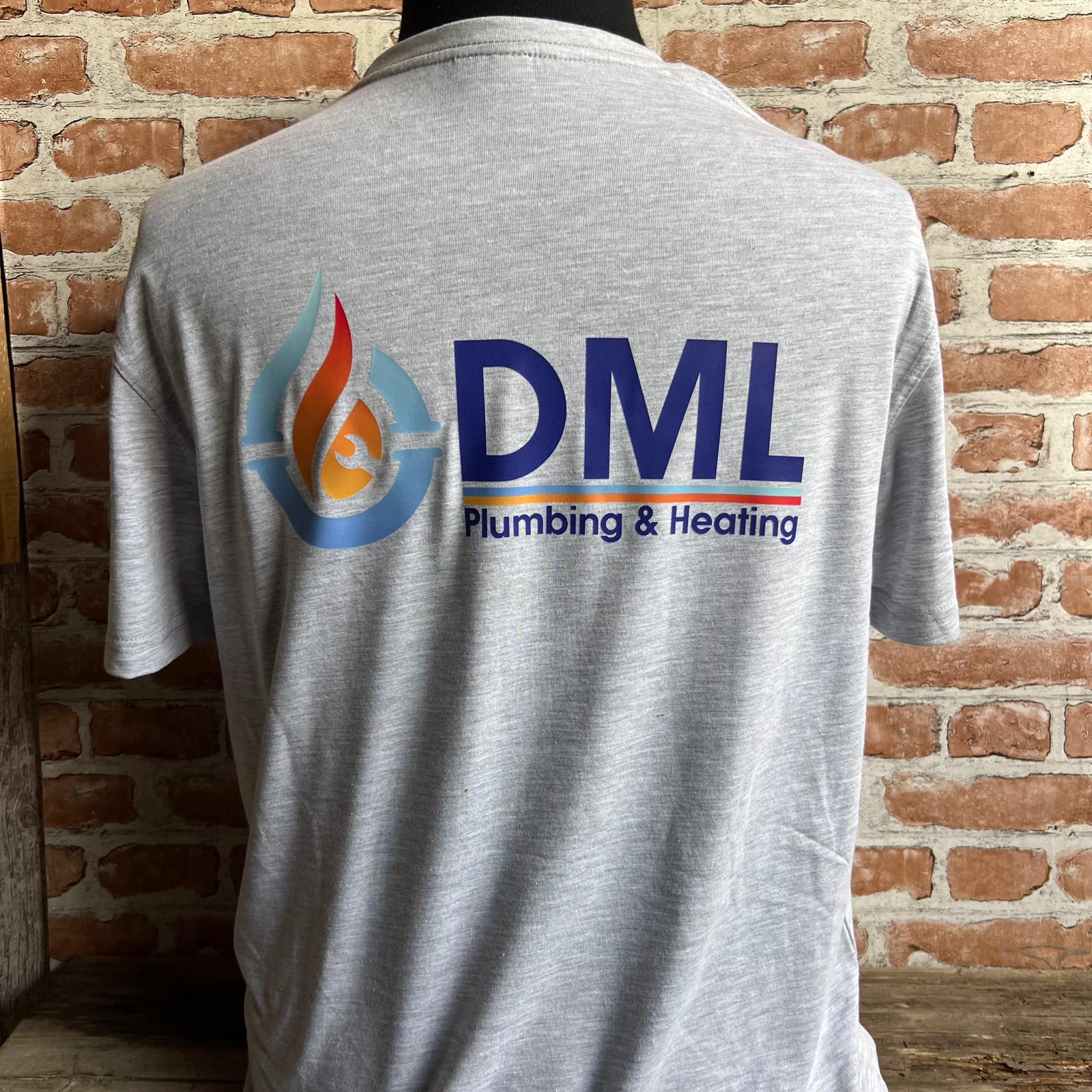 Gray t-shirt with DML Plumbing & Heating logo against a brick wall. Made by The Wrong End of Town in Dover, Kent.