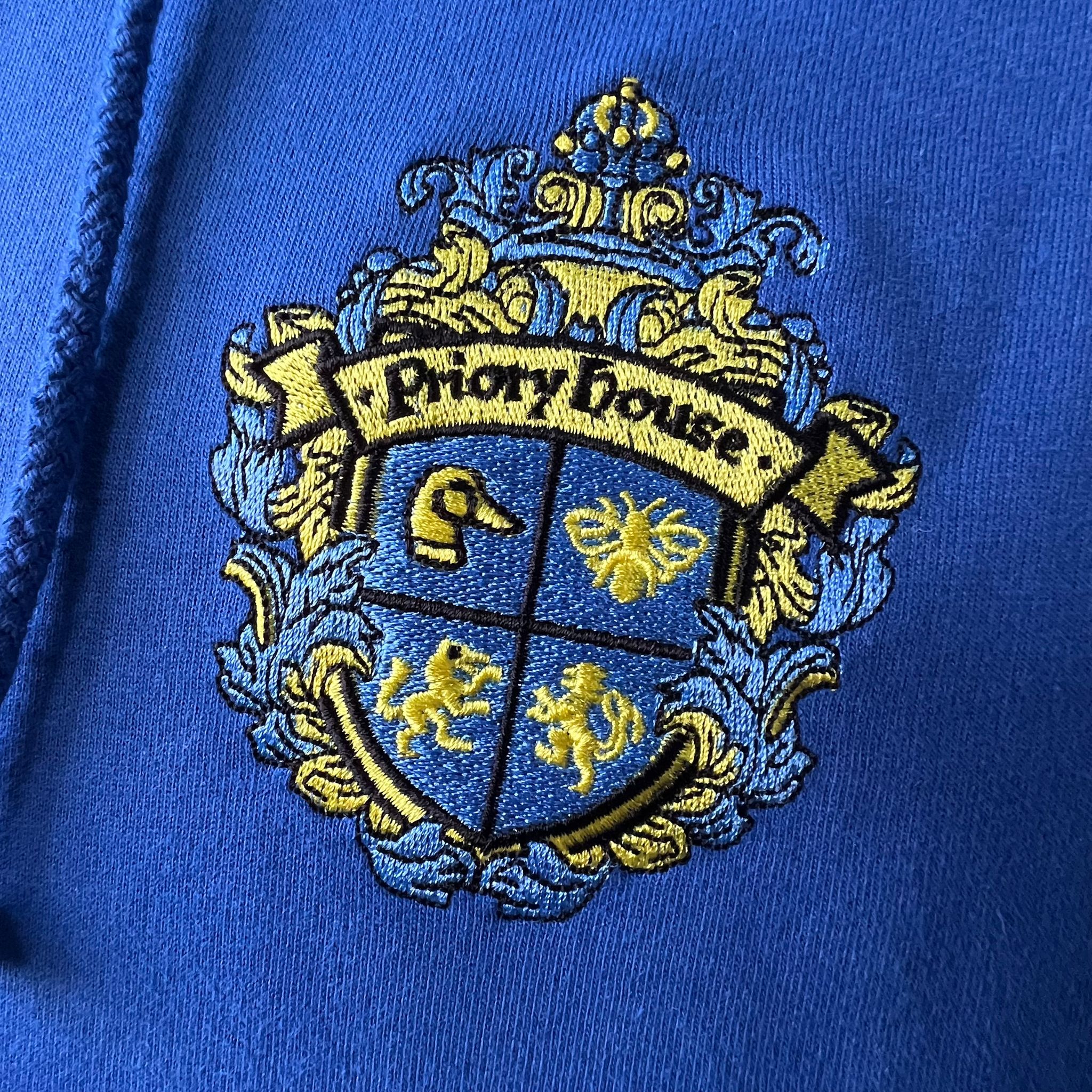Embroidered crest with 'Priory House' on a blue background. Made by The Wrong End of Town in Dover, Kent.